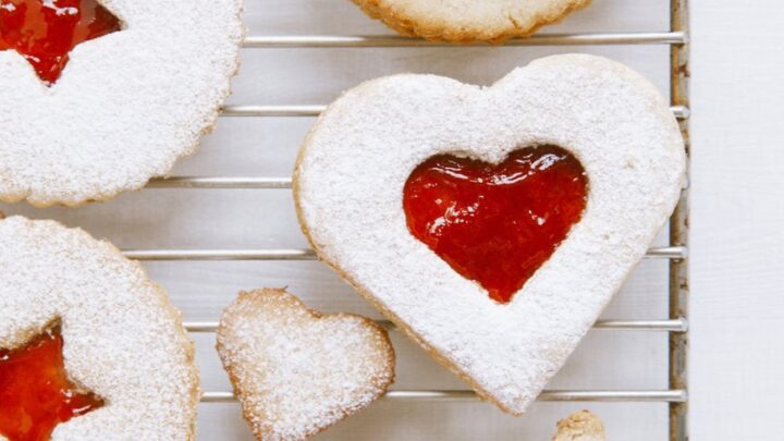 Top view of heart-shaped linzer cookies with raspberry jam