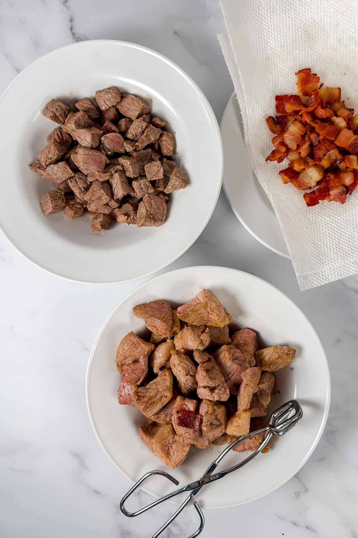 Three with browned beef, pork, and cooked bacon pieces for burgoo. 