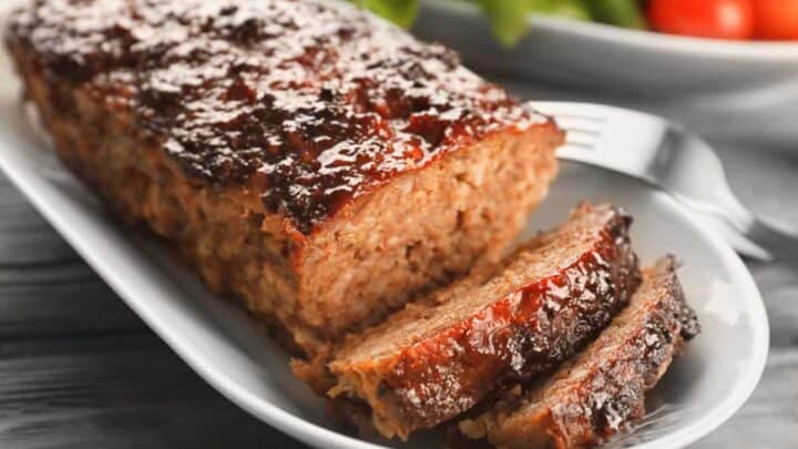 closeup view of sliced turkey meatloaf on a white plate