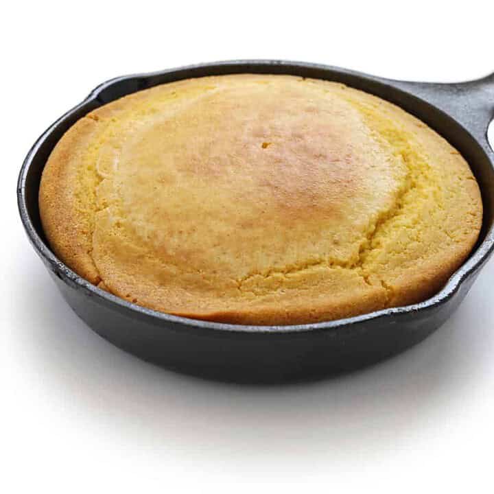 Side view of skillet cornbread in a cast iron skillet