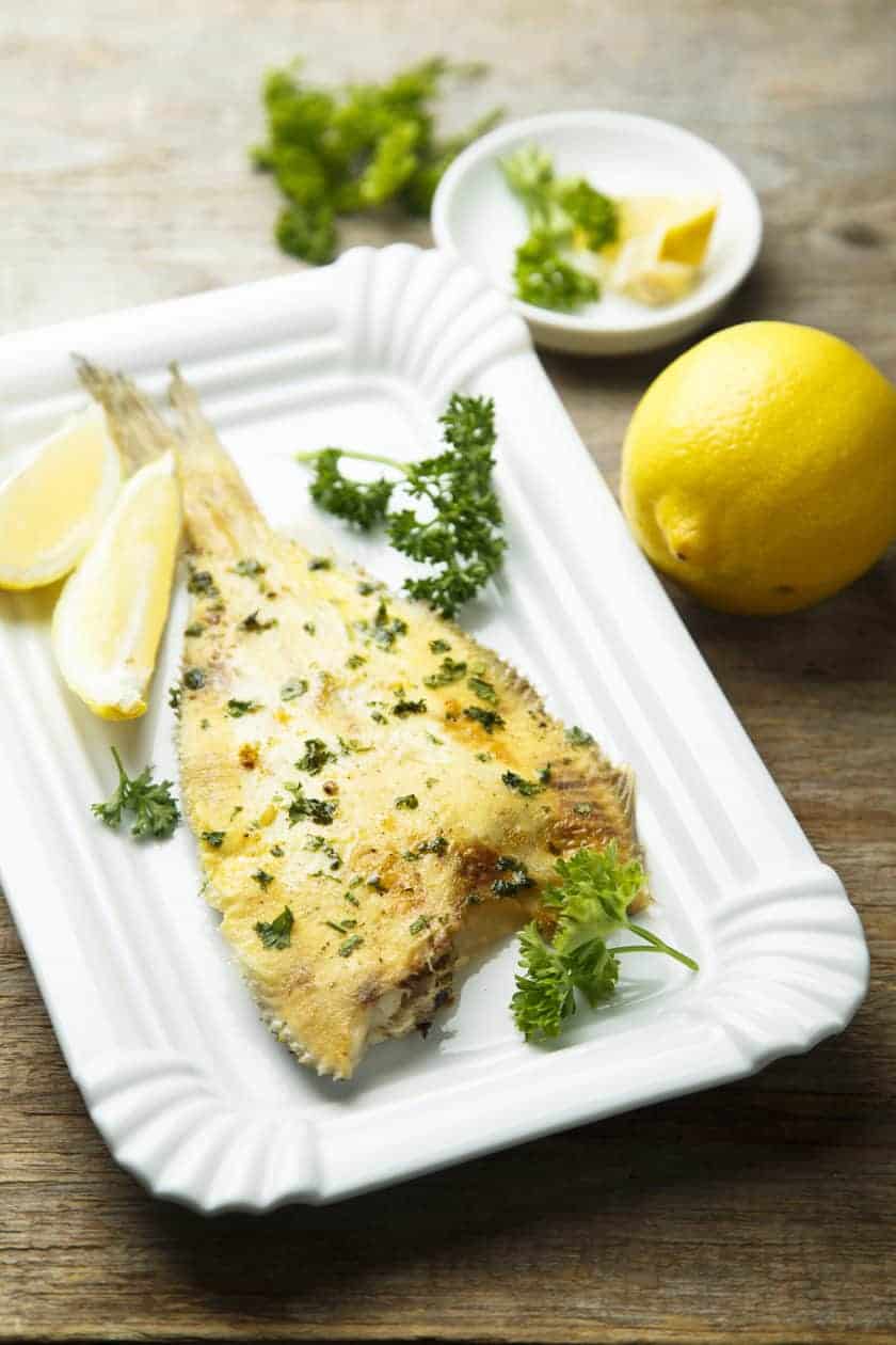 Baked Flounder with Lemon Pepper and Parsley on a platter