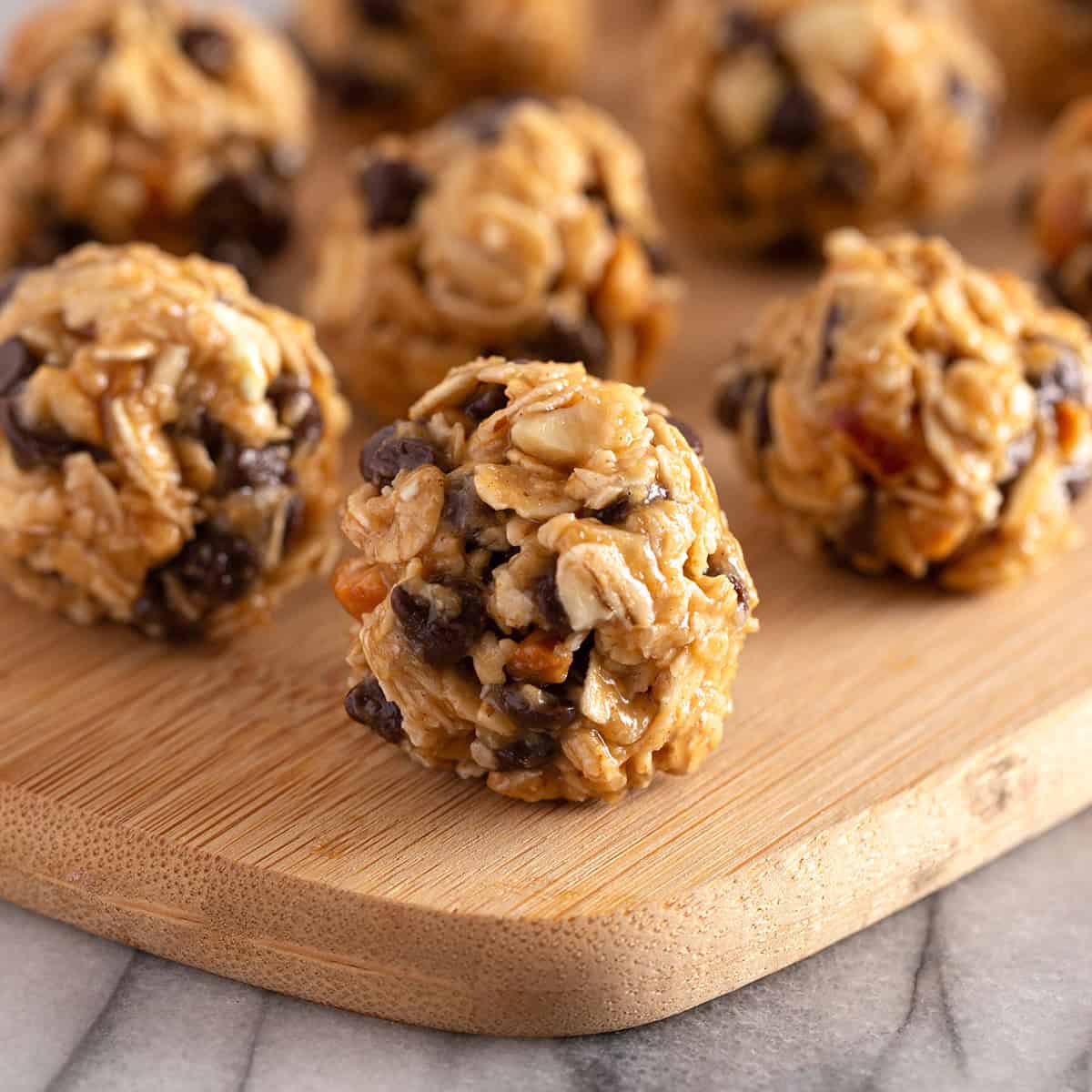 Closeup view of a peanut butter energy ball with more in the background.