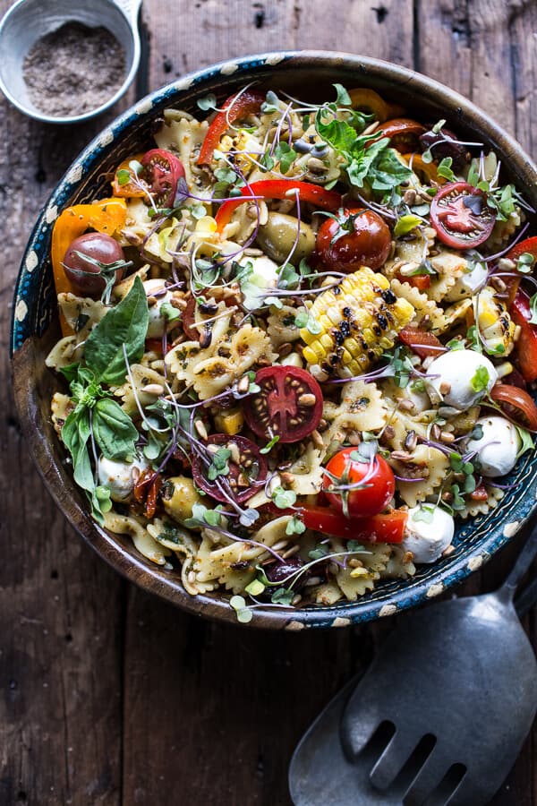 Pasta salad with pesto, cheese, corn, tomatoes and peppers