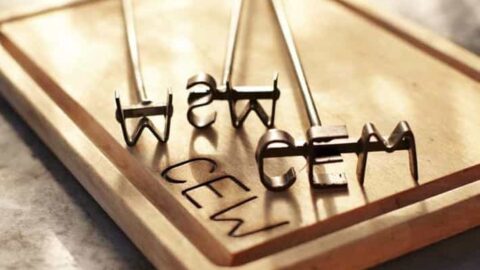 Three metal branding irons spelling "CEM" rest on a wooden tray, their letters imprinted below on the wood surface—a unique choice among Father's Day gift ideas.