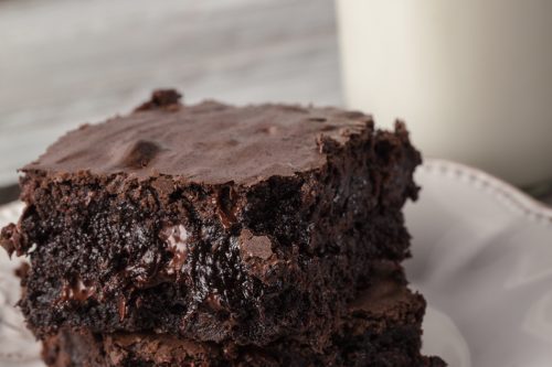 Stack of Dark Chocolate Brownies with a glass of milk