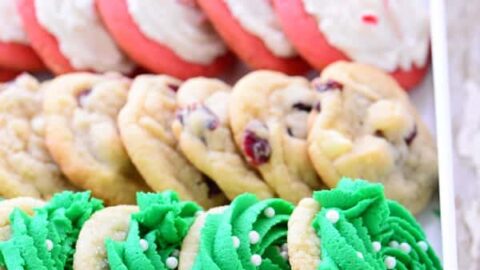 A white tray with four rows of cookies—green frosted, chocolate chip, pink and white, and chocolate—perfect for displaying your Make Ahead Christmas Cookies at holiday gatherings.