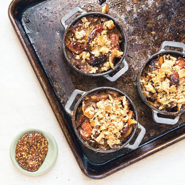 Cast Iron Pots of Bean Sausage Stew on a Baking Sheet