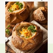 Pinterest Pin image of warm broccoli cheddar soup in a sourdough bread bowl ready for serving.