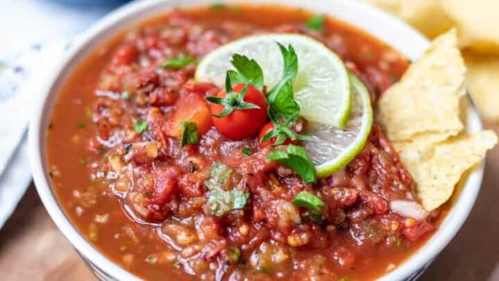 Side view of Homemade Salsa in a blue bowl with tortilla chips