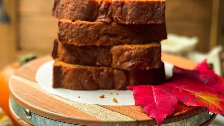 Sliced and Stacked Pumpkin Bread on a Wood Serving Platter