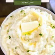 Pinterest Pin image of a bowl of crockpot mashed potatoes with pats of butter and the words, "Slow Cooker Mashed Potatoes".