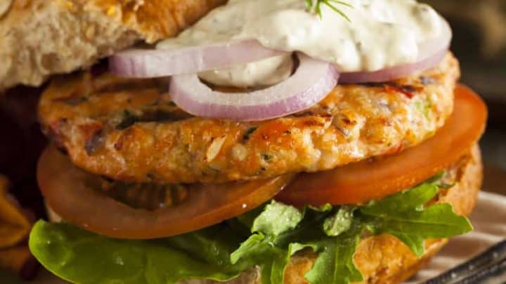 Salmon Burger topped with Red Onions and Tartar Sauce