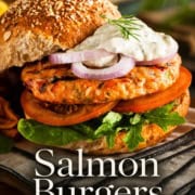 A salmon burger with lettuce, tomato, red onion, and sauce sits in a whole grain bun. Text reads "Delicious salmon burgers in around 15 minutes.