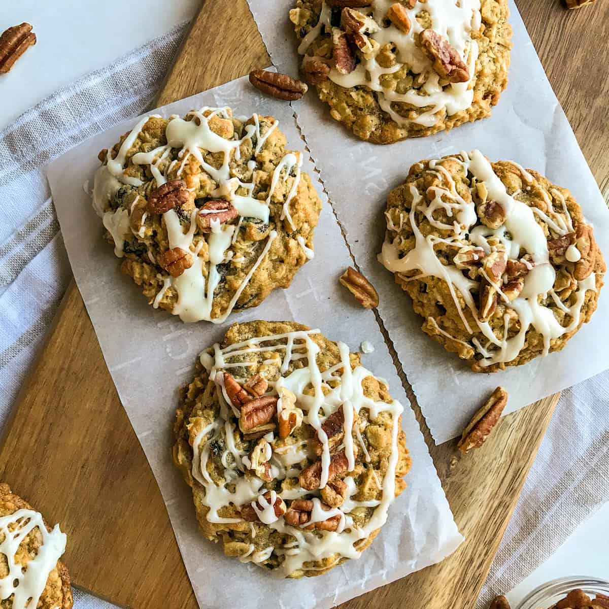 Oatmeal Raisin Cookies with maple and pecan on a parchment lined serving board.
