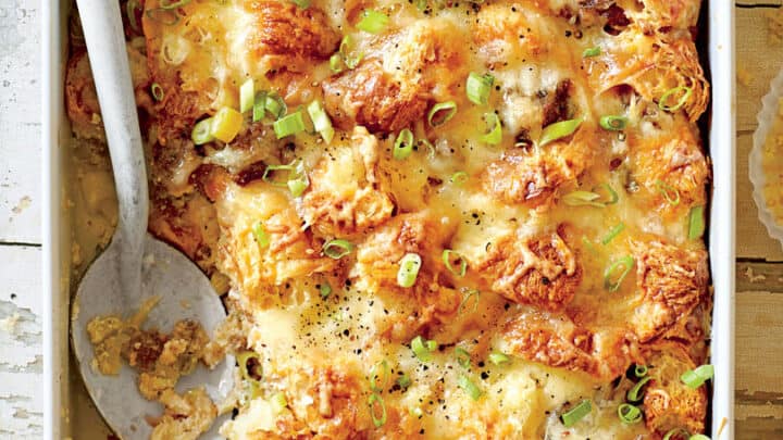 Top view of baked Asparagus Egg Bake Breakfast Casserole in an oval casserole dish with fresh parsley as garnish.