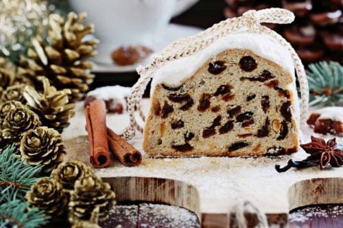 Front view of sliced Dresden Stollen on a wood cutting board