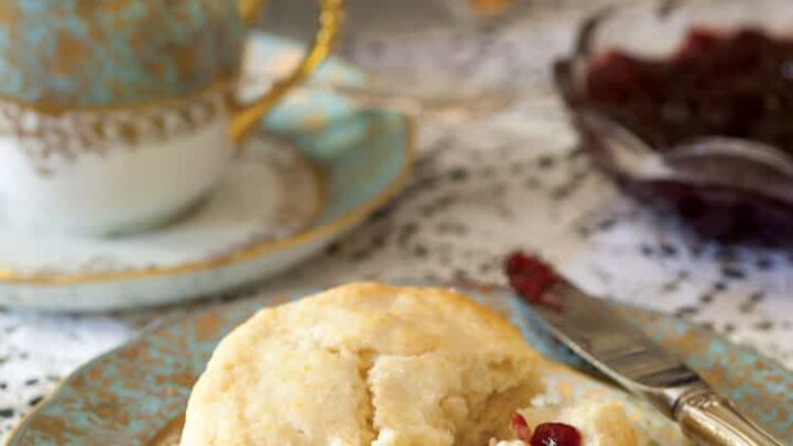 Scones with clotted cream and jam on a turquoise and white plate and served for a Winter Afternoon Tea.
