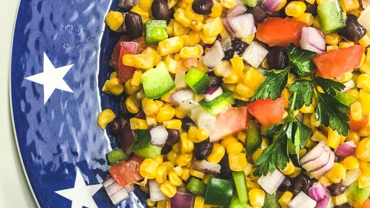 Closeup of Mexican Corn Salad on a blue star plate