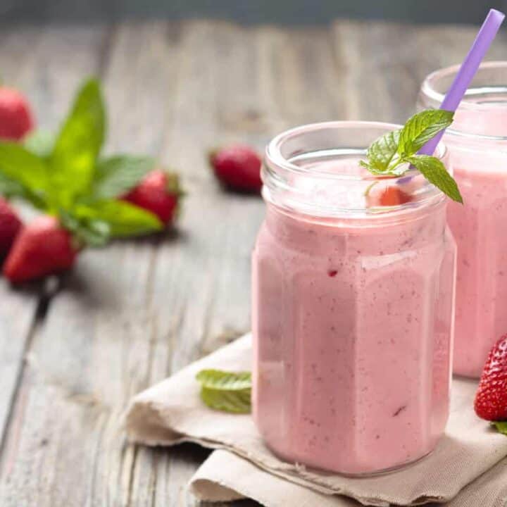 Healthy Homemade Strawberry and Banana Smoothie in a glass jar with a straw