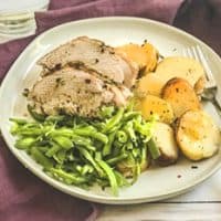 plate of pork tenderloin with green beans and potatoes