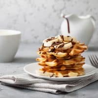 stack of banana waffles on a white plate