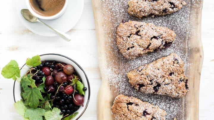 Black Currant Scones on a Wooden Board with Confectioners' Sugar
