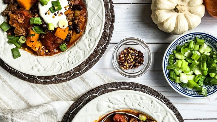 Side view of Three Sisters Stew in a covered casserole with stewed vegetables
