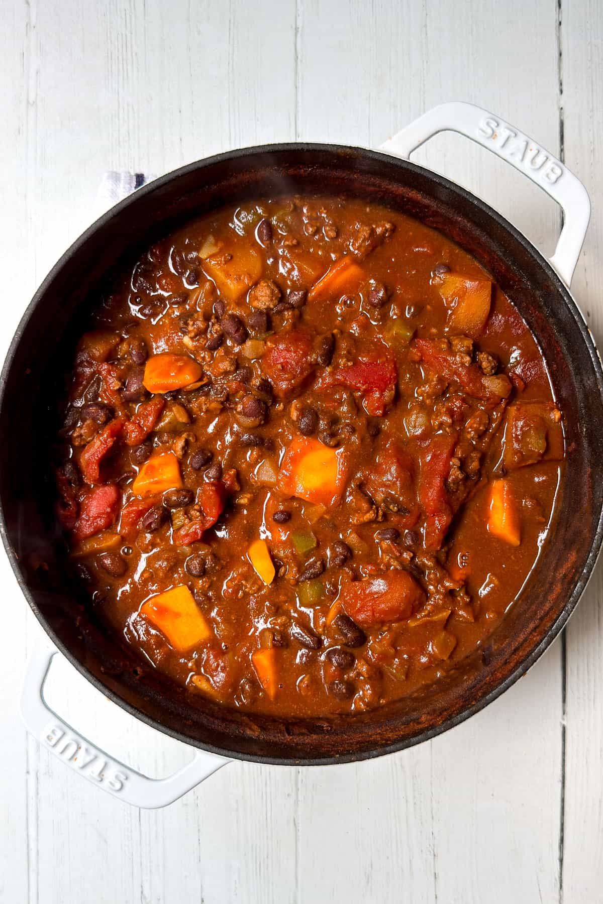 Cooked beef and butternut squash chili in a large pot ready for serving.