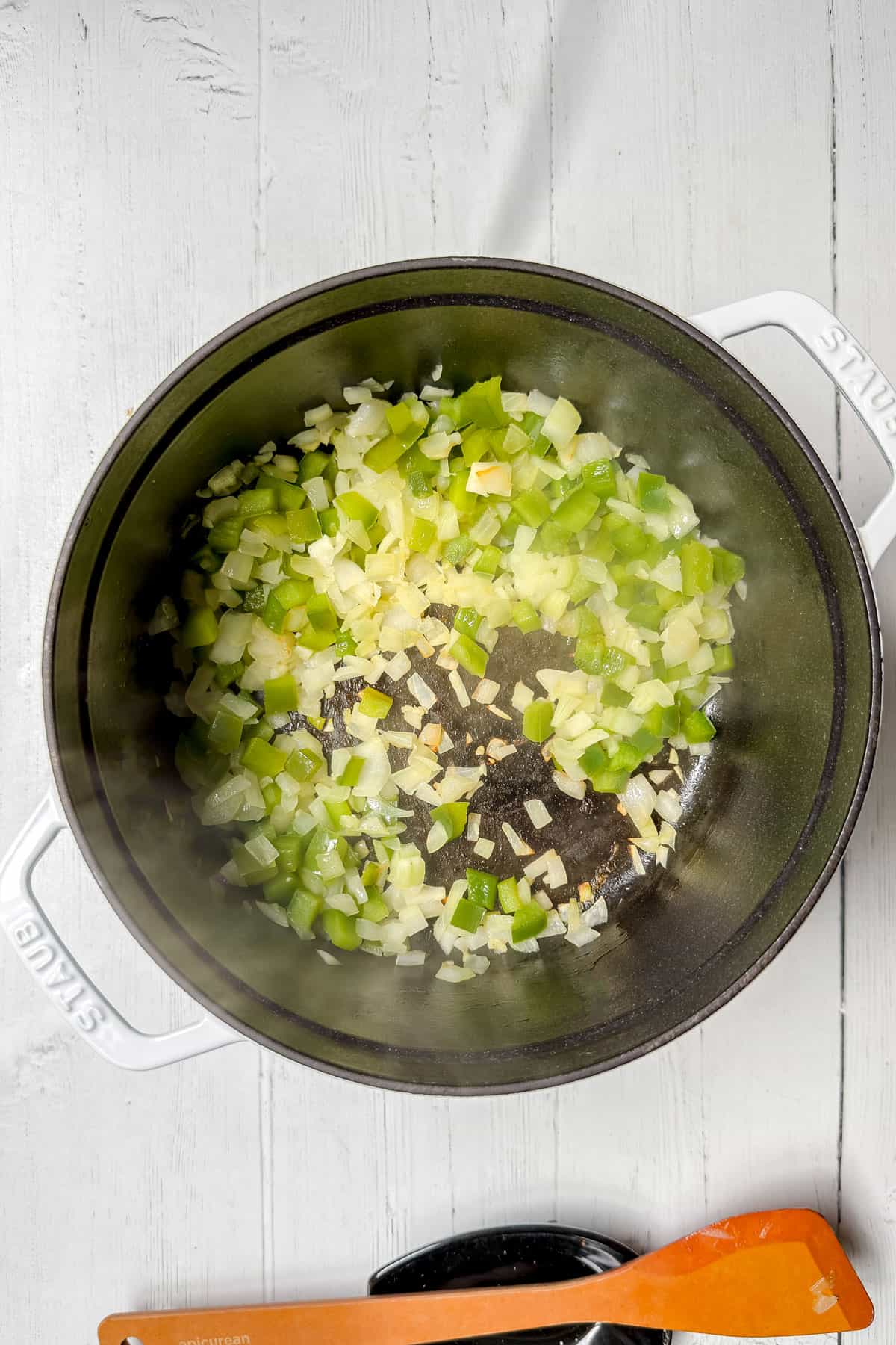 Sautéing onions, peppers, and garlic until the onion begins to brown for flavor.