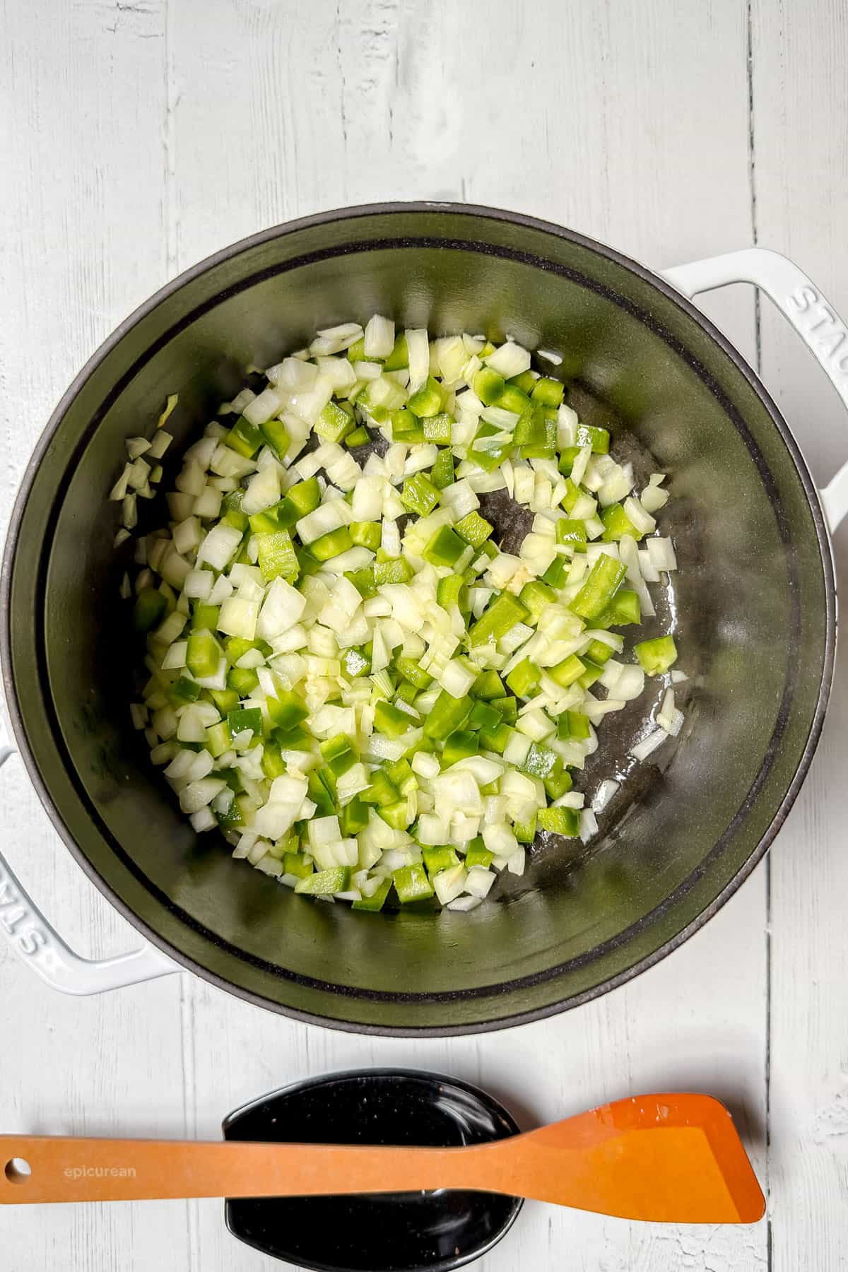 Sauteeing onions, garlic, and peppers in a large pot.