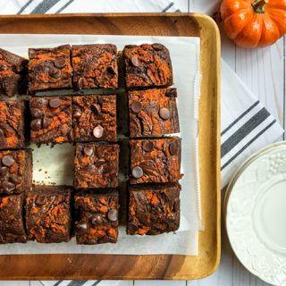plate of mocha pumpkin brownies on wooden board