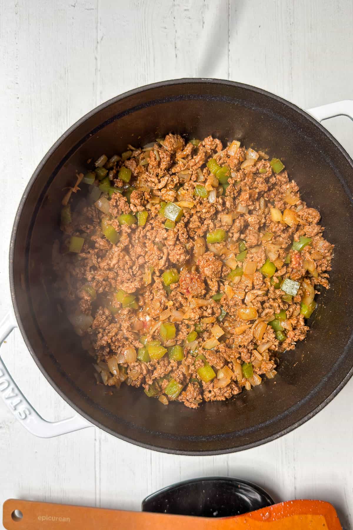 Ground beef browning in a large pot with onions, peppers, and garlic for beef butternut squash chili.