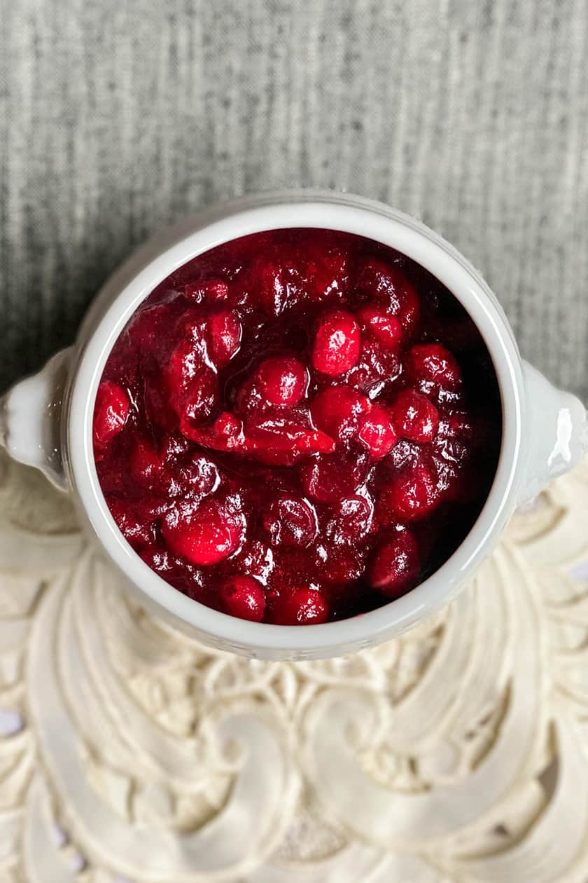 Overhead view of cranberry sauce in footed white bowl
