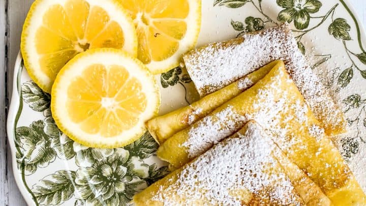 Quartered Shrove Tuesday Pancakes on a Green and White Plate