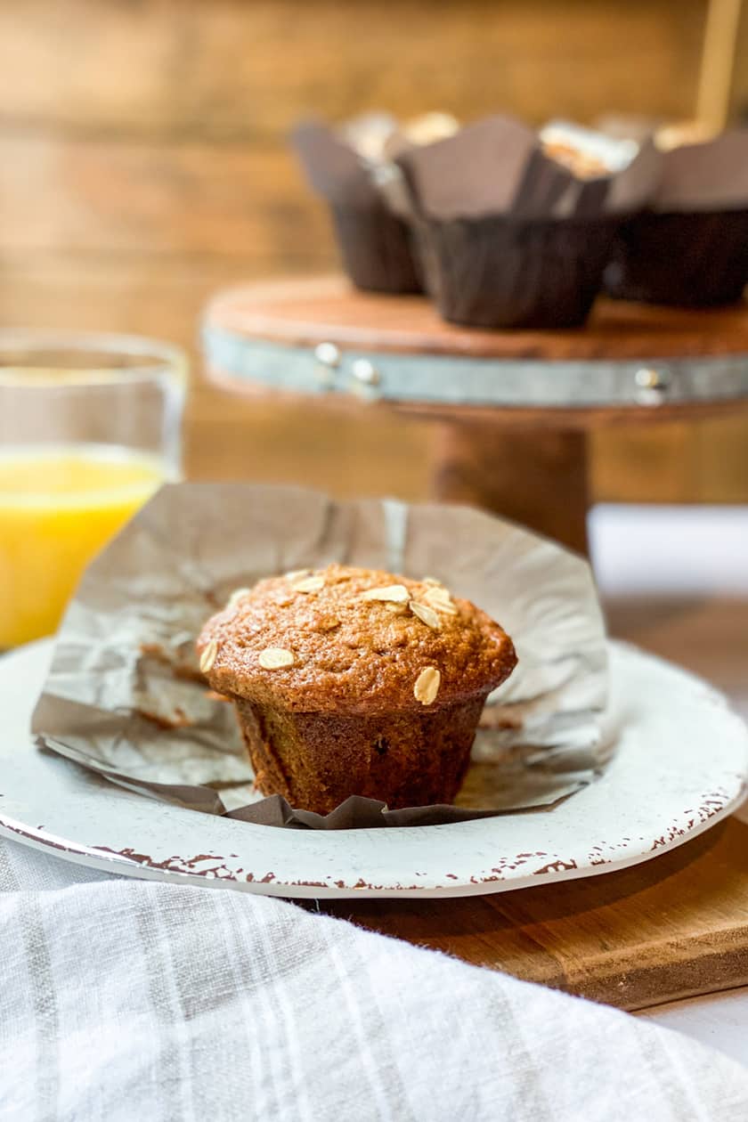 Unwrapped Morning Glory Muffin on a Plate with Orange Juice