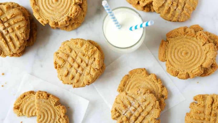 Peanut butter granola bars with chocolate chips arranged in neat rows on parchment paper.