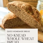 Halved loaf of Dutch Oven No Knead Whole Wheat Bread on a serving board for a Pinterest Pin.