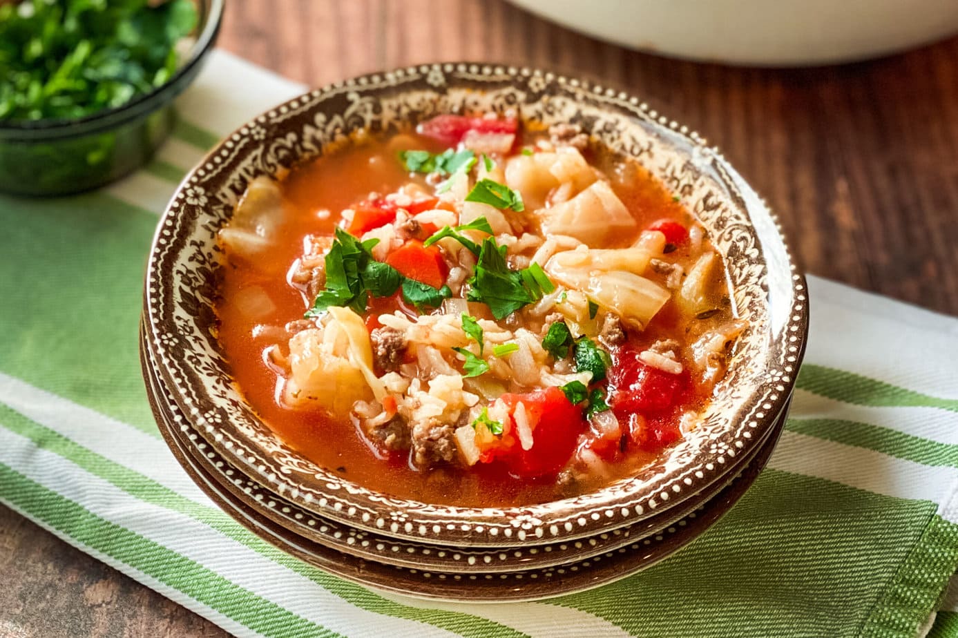 Side view of Cabbage Roll Soup in a brown and white bowl