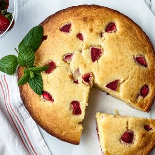 Closeup view of Strawberry Ricotta Cake with a Slice Missing