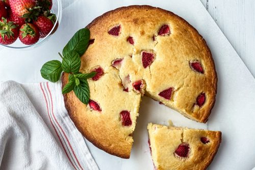 Closeup view of Strawberry Ricotta Cake with a Slice Missing