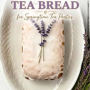 A loaf of lavender tea bread with white glaze, garnished with lavender sprigs, sits on an ornate white platter. Text overlays promote this lavender tea bread as the perfect treat for springtime tea parties.