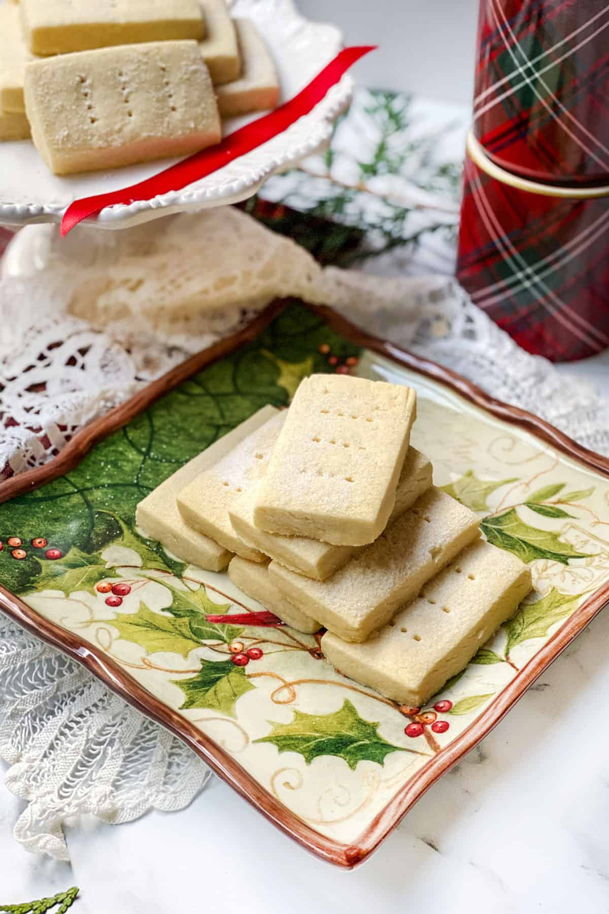 Stack of Buckingham Palace Shortbread Cookies on a festive plate.