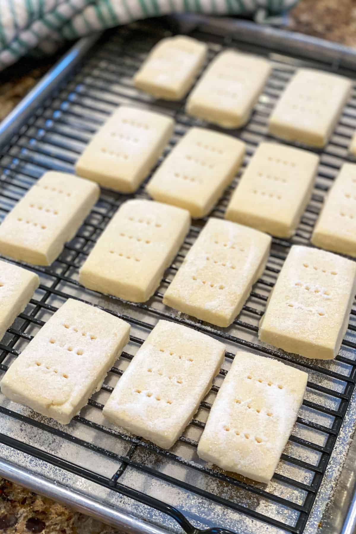 Baked shorbread cookies cooling on a rack and sanded with granulated sugar.