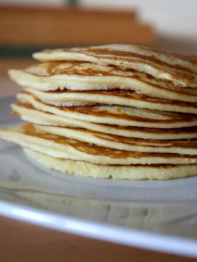 Stack of protein pancakes on a white plate