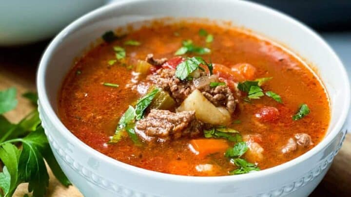 Two bowls of Hamburger Soup with fresh parsley as garnish.