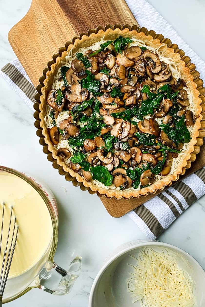 Layers of unbaked Easy Mushroom and Kale Quiche