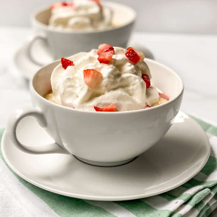 Strawberry Mug Cake with Whipped Cream and Diced Strawberries