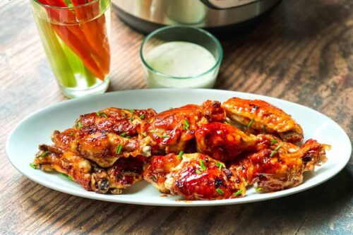 Instant Pot Buffalo Chicken Wings on a White Plate with Carrots, Celery and Ranch Dressing