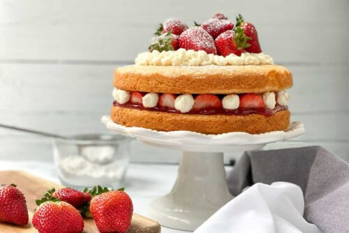 A simple, 2 layer Victoria Sponge Cake, layered with fresh strawberries and cream.