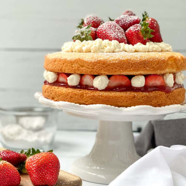 A simple, 2 layer Victoria Sponge Cake, layered with fresh strawberries and cream.